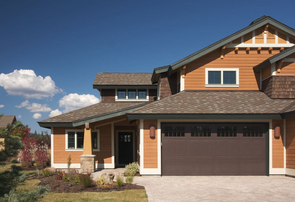 A home with brown siding and a garage.