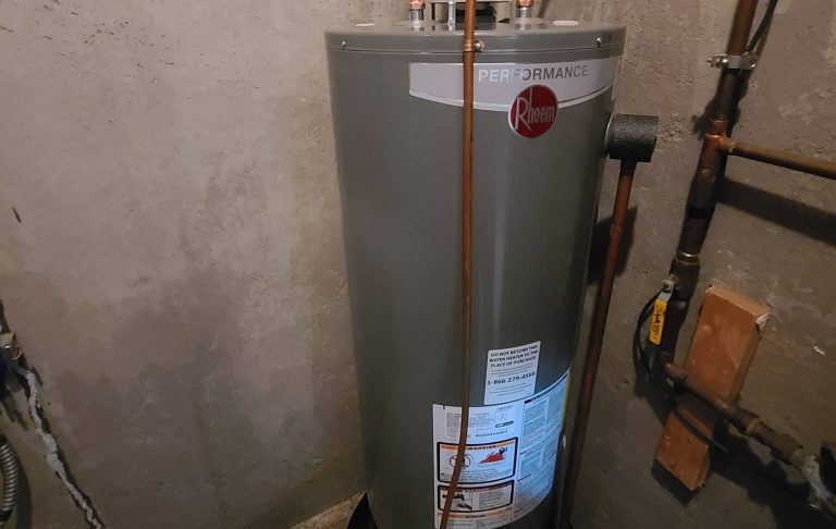 A water heater in a room with pipes.